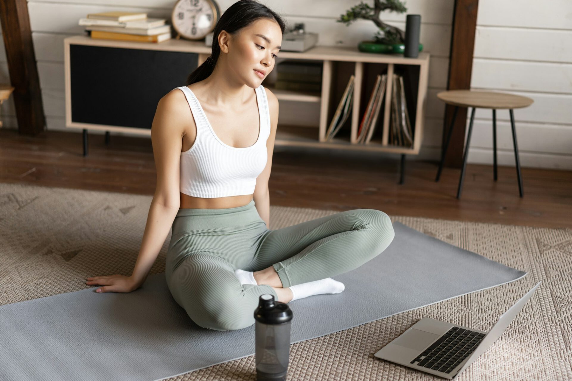 Sport and lifestyle. Young asian girl follow online trainer instructions, workout using video course